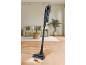 Cordless vacuum cleaner with mopping function, cleaning a spill on a wooden floor.