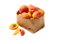 Fresh apricots in a paper bag, with some cut alongside.