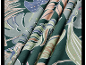 Fabric with a tropical leaf pattern in shades of green, blue, and beige.
