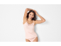 Smiling woman in light pink lace camisole and briefs.