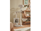 A fluffy cat playing on a multi-level cat tree with scratching posts and a hammock.