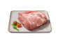 Piece of raw pork meat, garnished with tomatoes and vegetables on a platter.