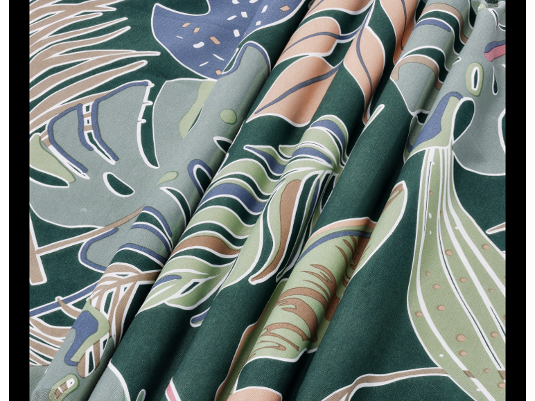 Fabric with a tropical leaf pattern in shades of green, blue, and beige.