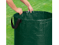 Person holding a garden waste bag against a green grass background.