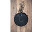 Robot vacuum cleaner on a wooden floor with dirt