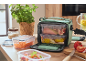 Lunch bag with food containers, including figs and beetroot, on a wooden table.