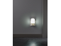 A night light plugged into a wall socket, illuminating a dark room.