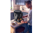 Man in kitchen using a black dual drawer air fryer.