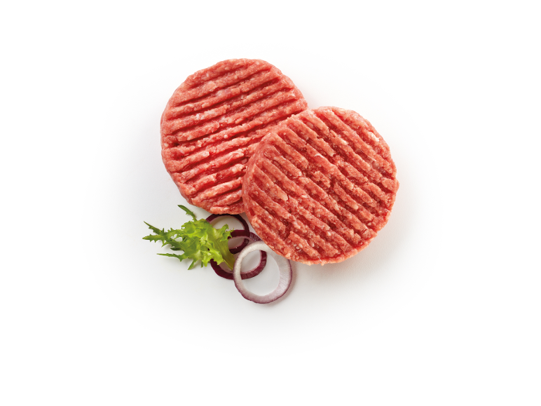 Two raw beef burger patties with lettuce and red onion on a white background.