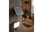 Solar floodlight with motion sensor mounted on an exterior wall