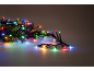 Multicoloured LED Christmas lights with fir branches, creating a festive atmosphere.