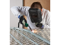 Person wearing a welding mask and gloves, welding metal parts.