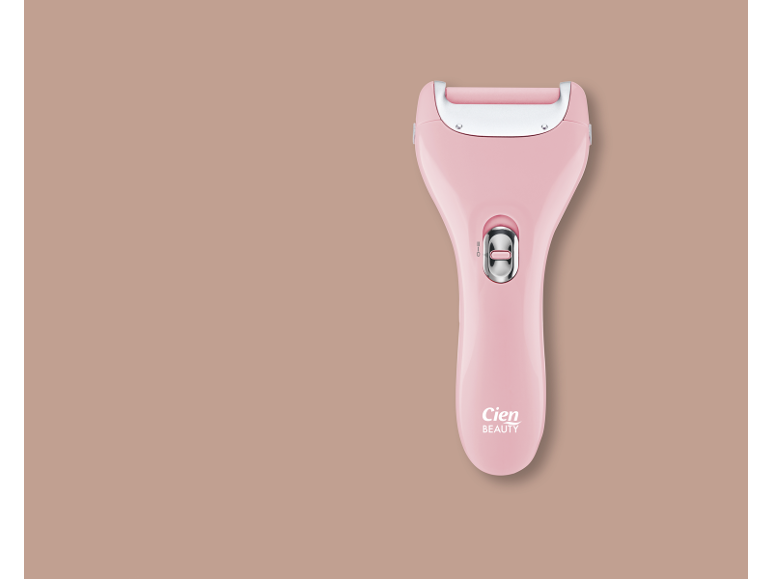 Pink electric callus remover on a beige background.