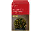 100 warm white LED solar string lights on a green bush in a pot.