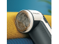 Lint remover on yellow knitted fabric.