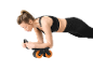 Woman in black sports bra and leggings doing a plank exercise with an ab roller.