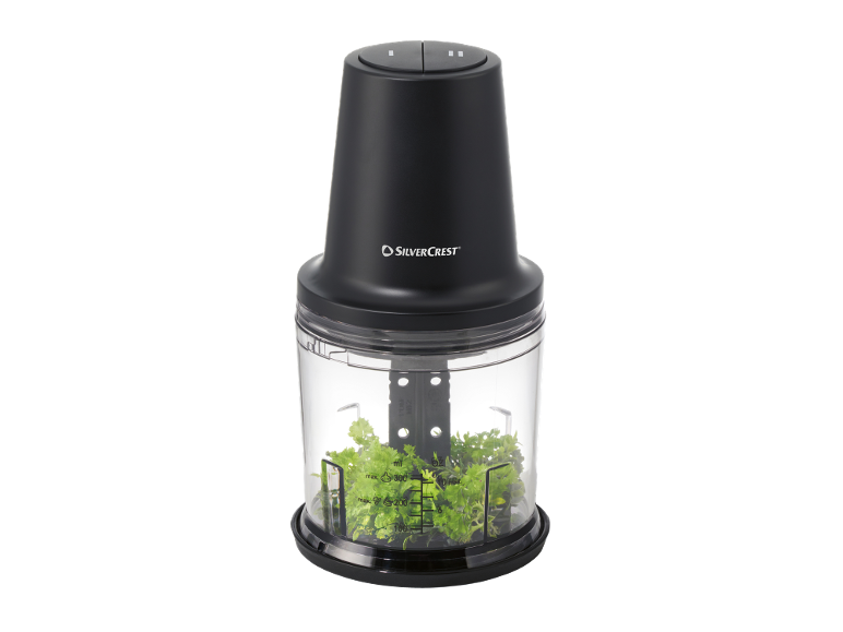 Black chopper with a transparent container filled with chopped parsley.