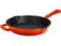 Orange cast iron frying pan with a black interior.