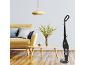 Cordless vacuum cleaner in a living room with a yellow sofa and wooden coffee table.