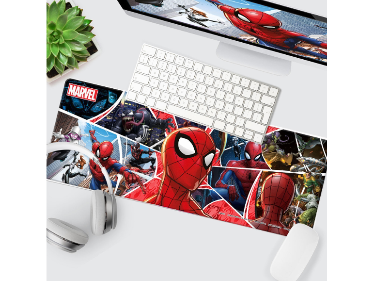 Desk setup with a comic-themed mouse pad featuring superheroes and villains, a keyboard, and headphones.