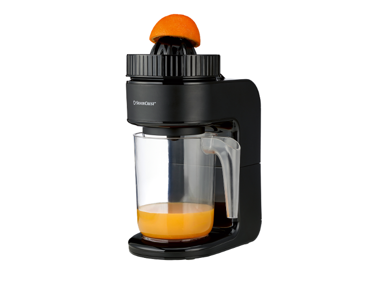 Black electric citrus juicer with a halved orange and fresh orange juice.
