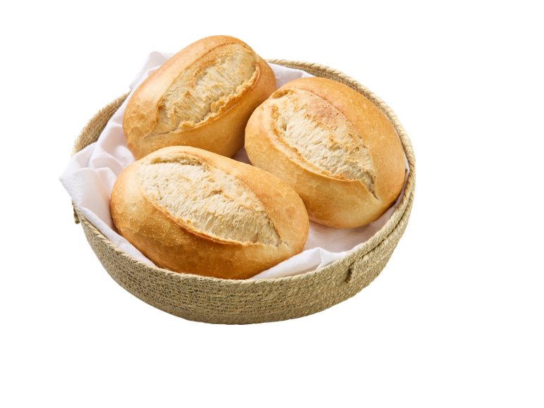 Three freshly baked bread rolls in a woven basket with a white napkin.