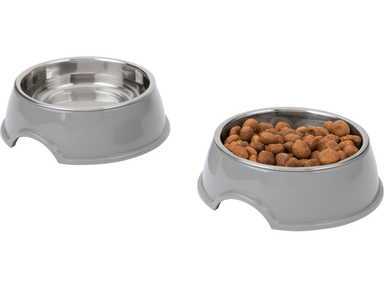 Two grey pet bowls, one empty and one filled with dry pet food.