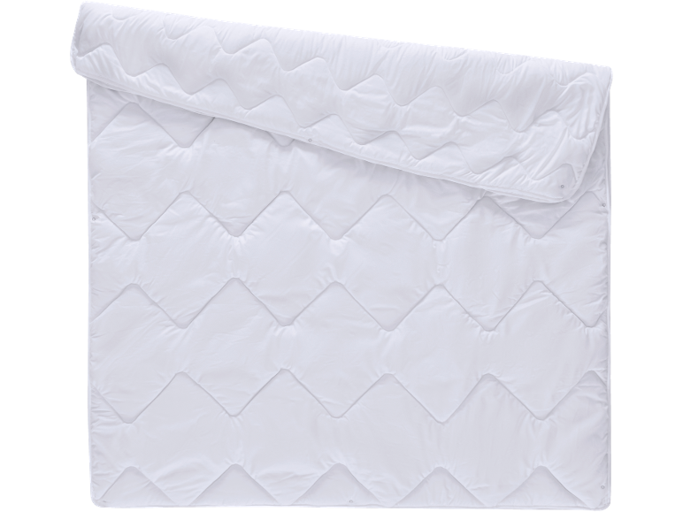 White quilted duvet with a zigzag pattern, partially rolled.
