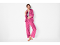Woman in fuchsia pink tracksuit, zip-up jacket and wide-leg pants.