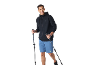 Smiling man in black hoodie, blue shorts, and trekking poles.