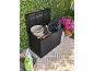 Black garden storage box filled with gardening tools, hose, and flower pot.
