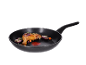 Roasted chicken leg with onion and carrot in a frying pan.