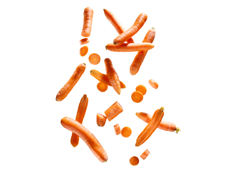 Fresh whole, halved, and sliced carrots floating against a white background.