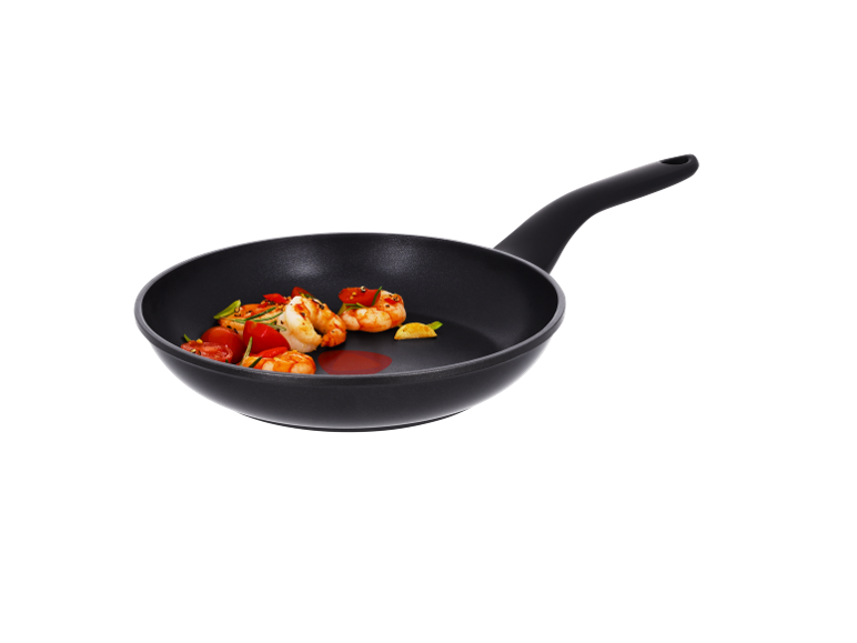Frying pan with shrimp, cherry tomatoes, and herbs.