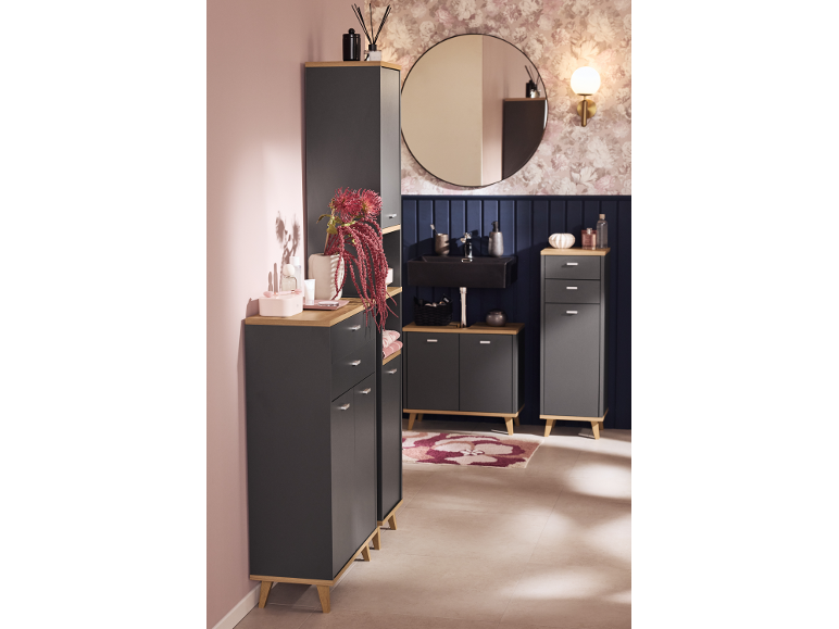 Modern bathroom with dark grey cabinets, wooden surfaces, and a round mirror.