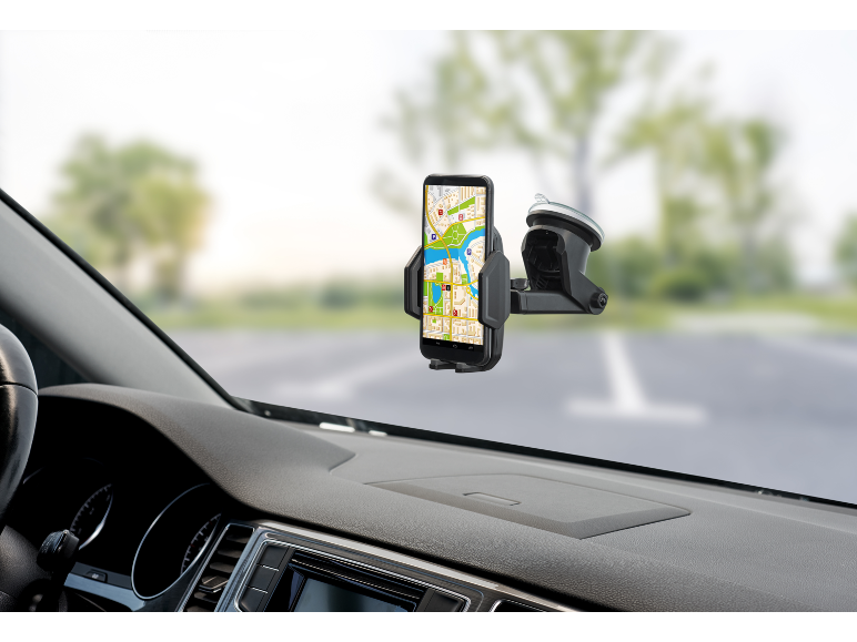 Smartphone with navigation in a car holder on the windshield.