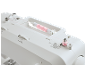 White sewing machine with pink thread being wound onto a bobbin.