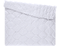 White quilted duvet with diamond pattern, partially folded.