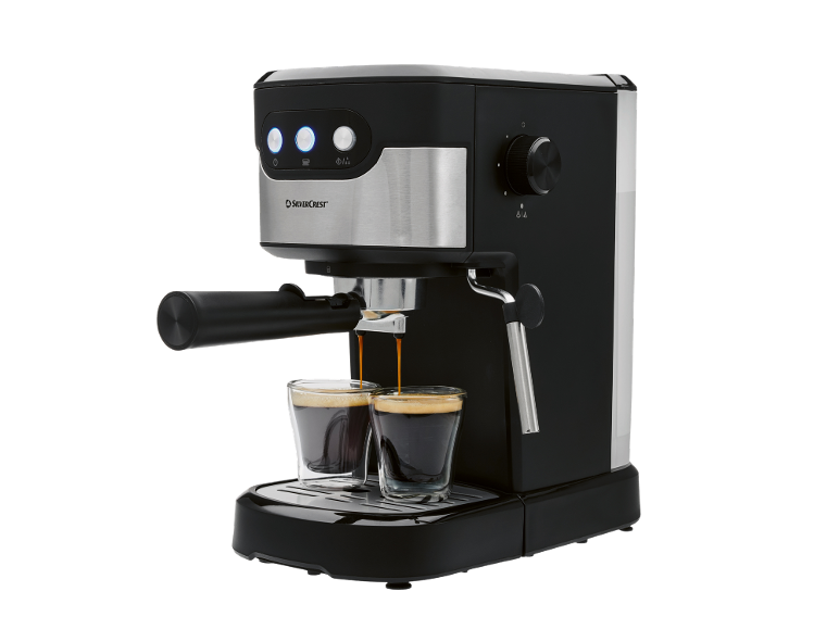 Black espresso machine brewing two cups of coffee.