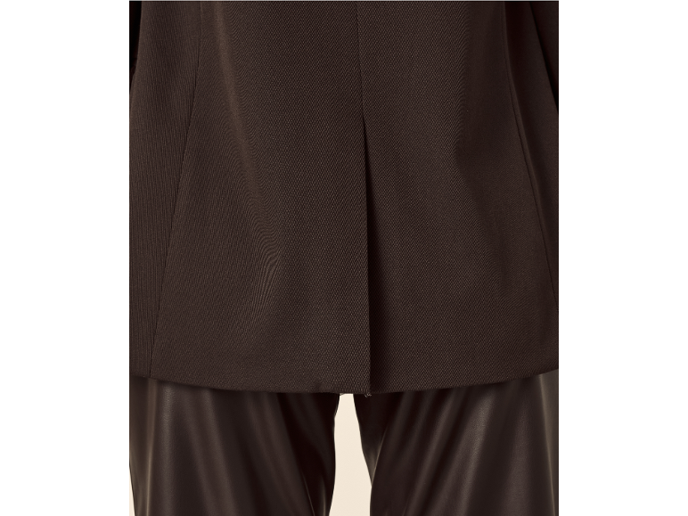 Back of a dark brown jacket over faux leather trousers.