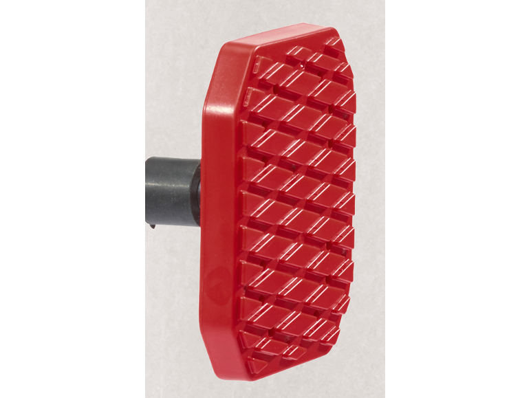 Close-up of a red textured foot pedal with a black attachment