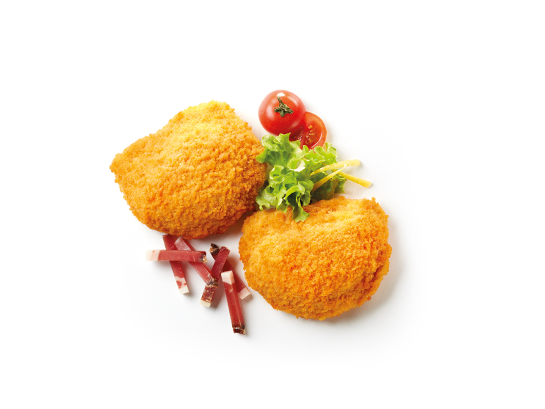 Two golden fried chicken cutlets with salad, cherry tomatoes, and prosciutto.