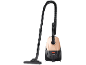 Beige and black vacuum cleaner with a hose and suction tube.