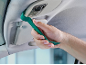 Car trim removal tool used to detach a ceiling light.