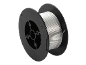 Silver welding wire spool with black holder, with the inscription '>PS<'