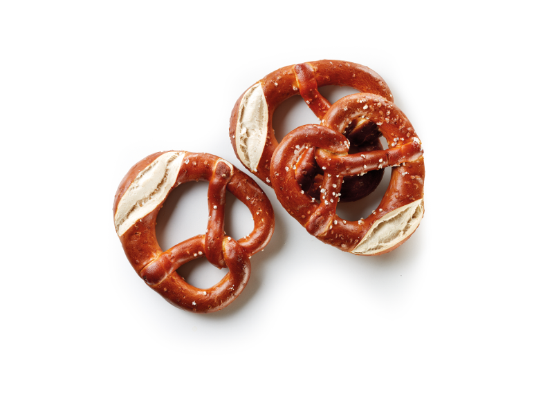 Salted pretzels with golden-brown crust and white interior, on a white background.