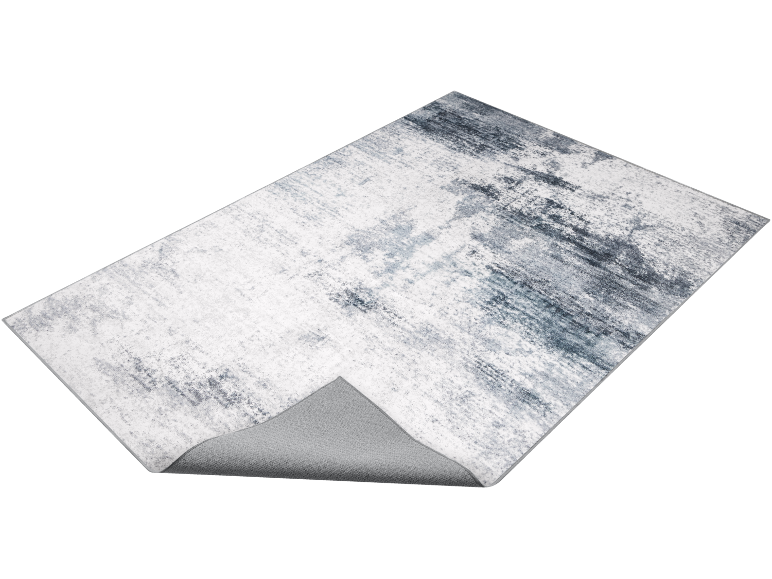 Abstract grey and white rug with a distressed pattern, showing the underside