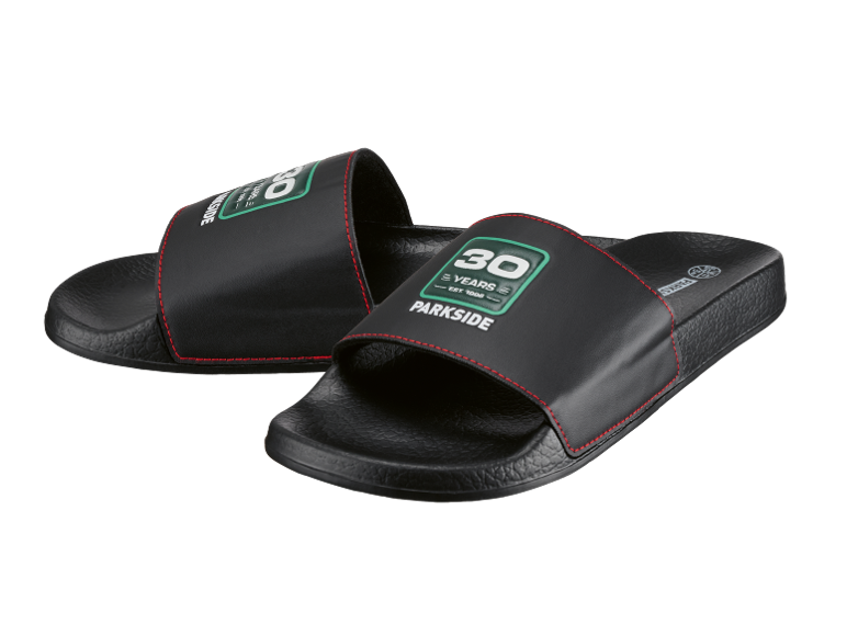 Black slides with red stitching and green 