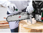 Sharpening a chainsaw chain with a file, secured by a vise.