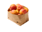 Fresh apricots in a brown paper bag.